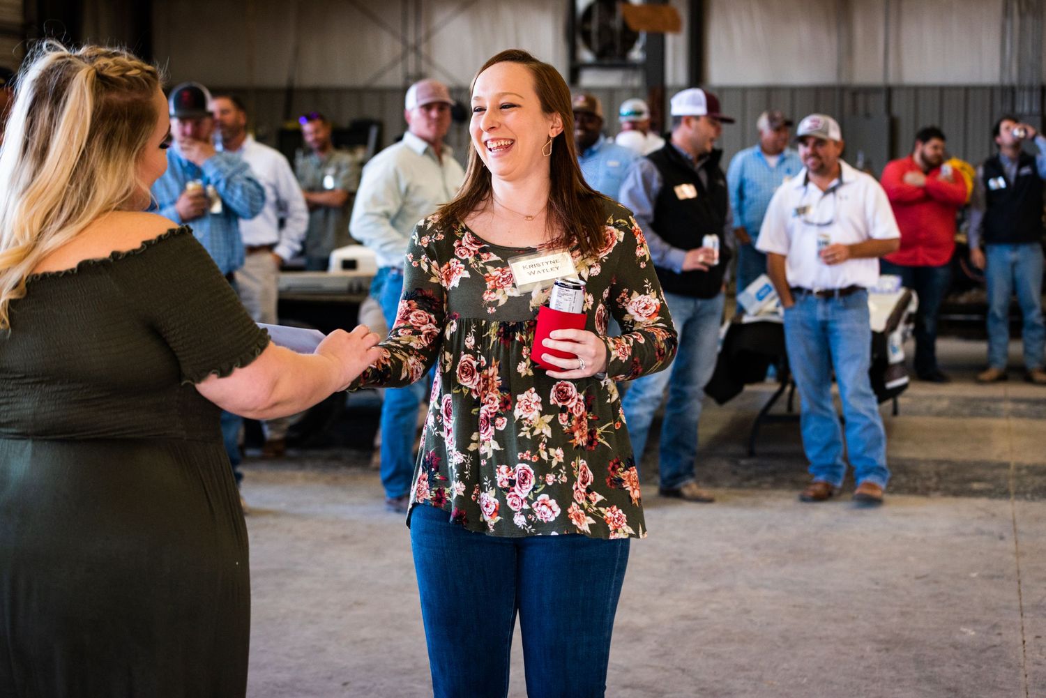 Attendees socializing at casual indoor corporate event.