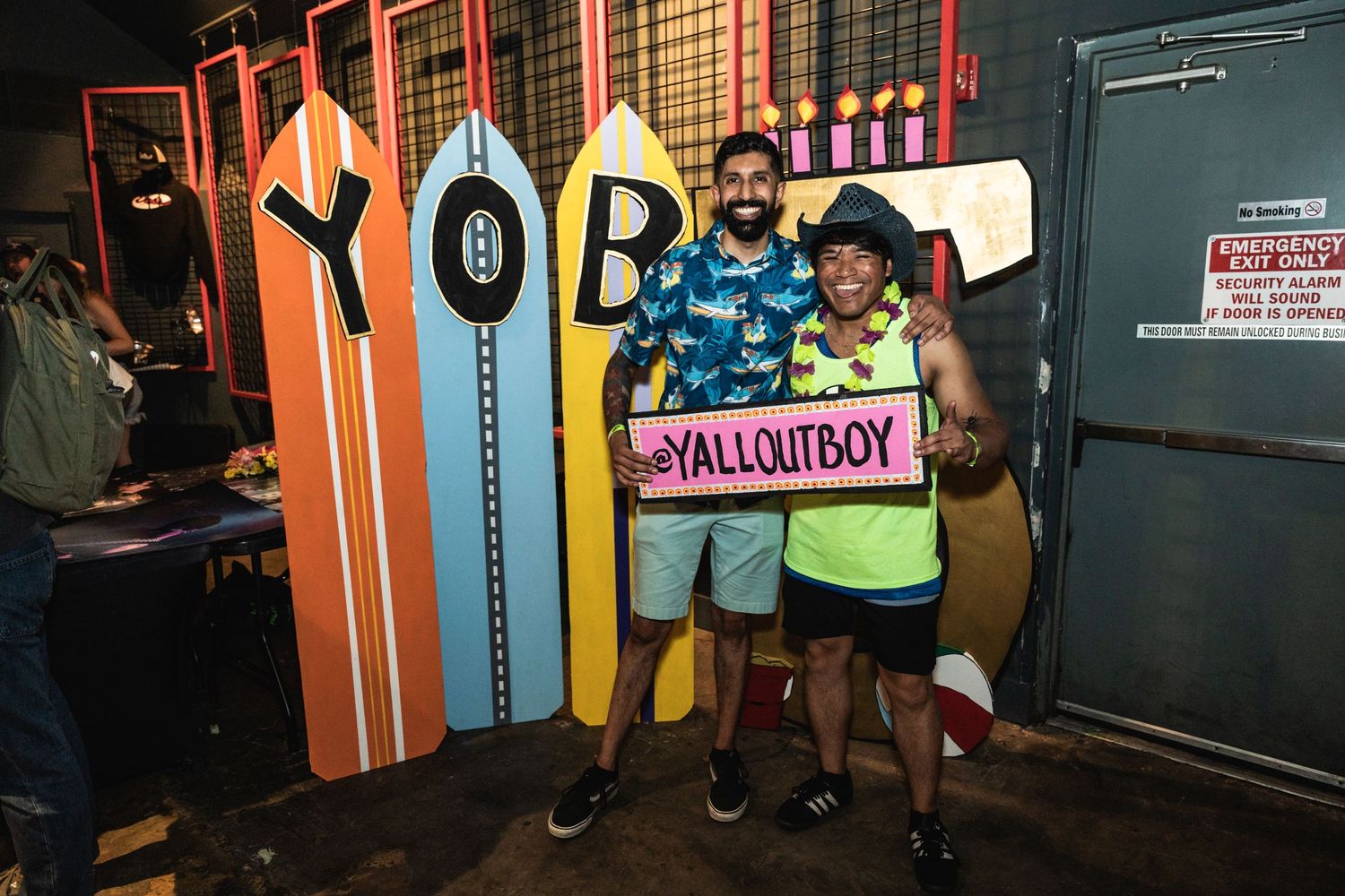 Colorful surfboard-style wall display with YallOutBoy branding.