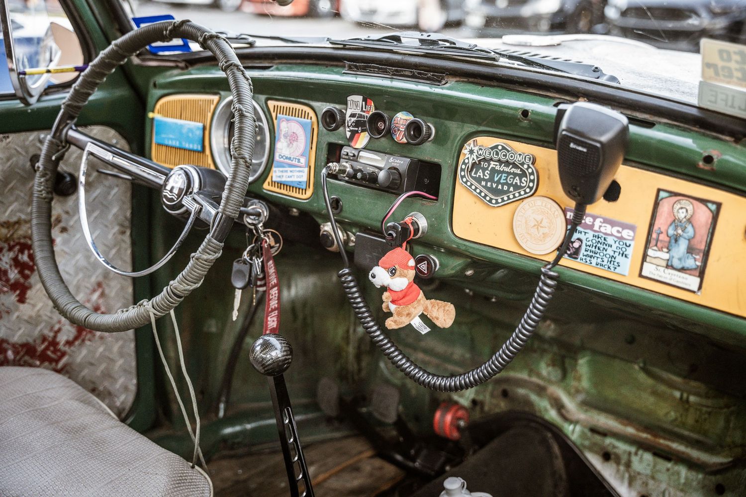 Vintage car dashboard with retro decorations and stickers showing nostalgic personality.
