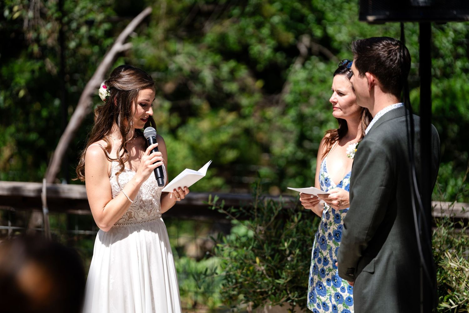 Wedding ceremony participants share joyful moment during outdoor celebration.
