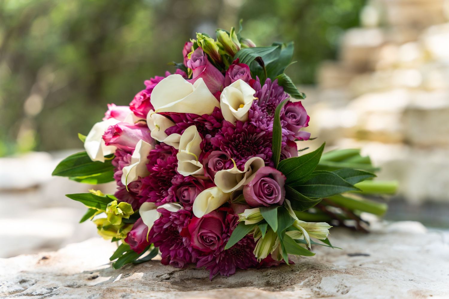 Stunning bridal bouquet with pink roses, white calla lilies and deep magenta peonies.