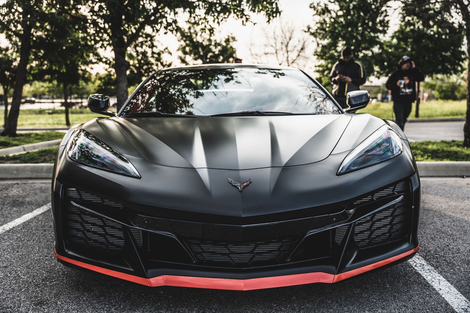 Front view of black Chevrolet Corvette ZR1 with aggressive red-trimmed front splitter.