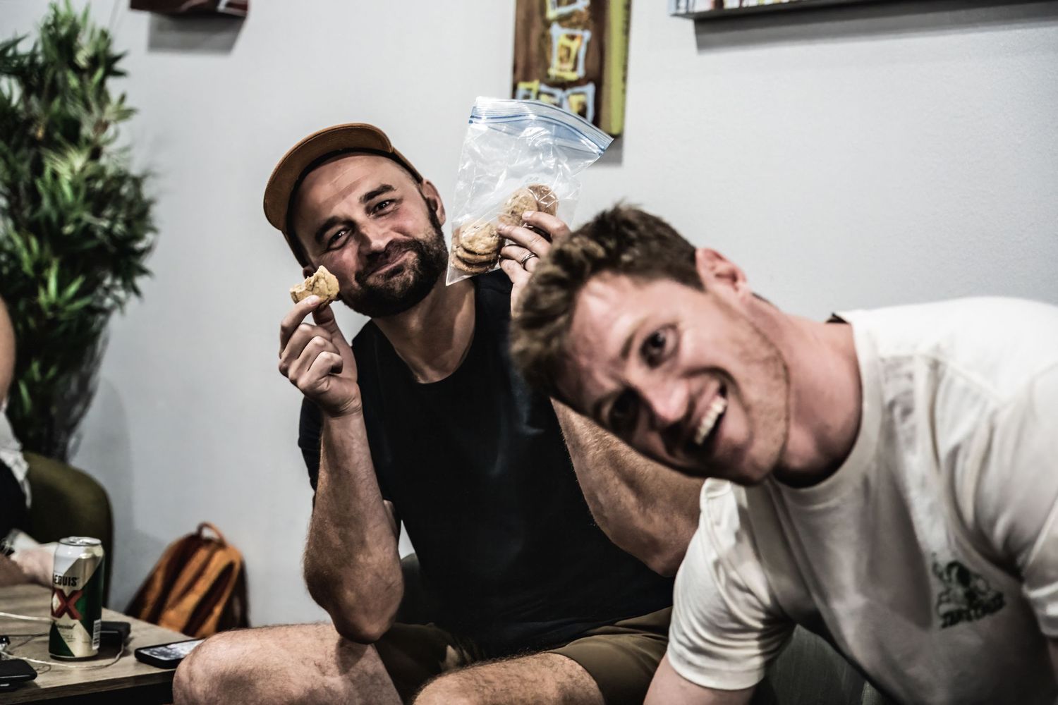 Two friends having fun and joking around while hanging out indoors.