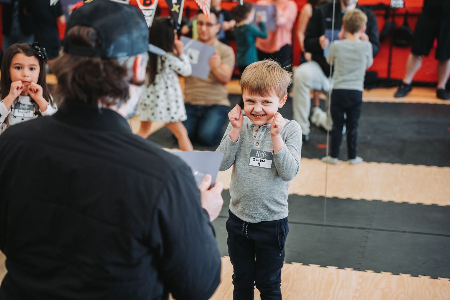 Young student practices defensive stance during martial arts training session.