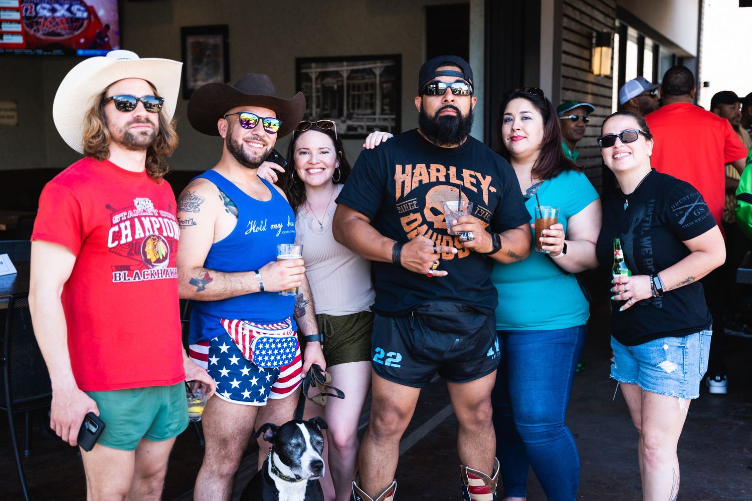 Group photo at casual gathering wearing festive summer outfits and patriotic attire.