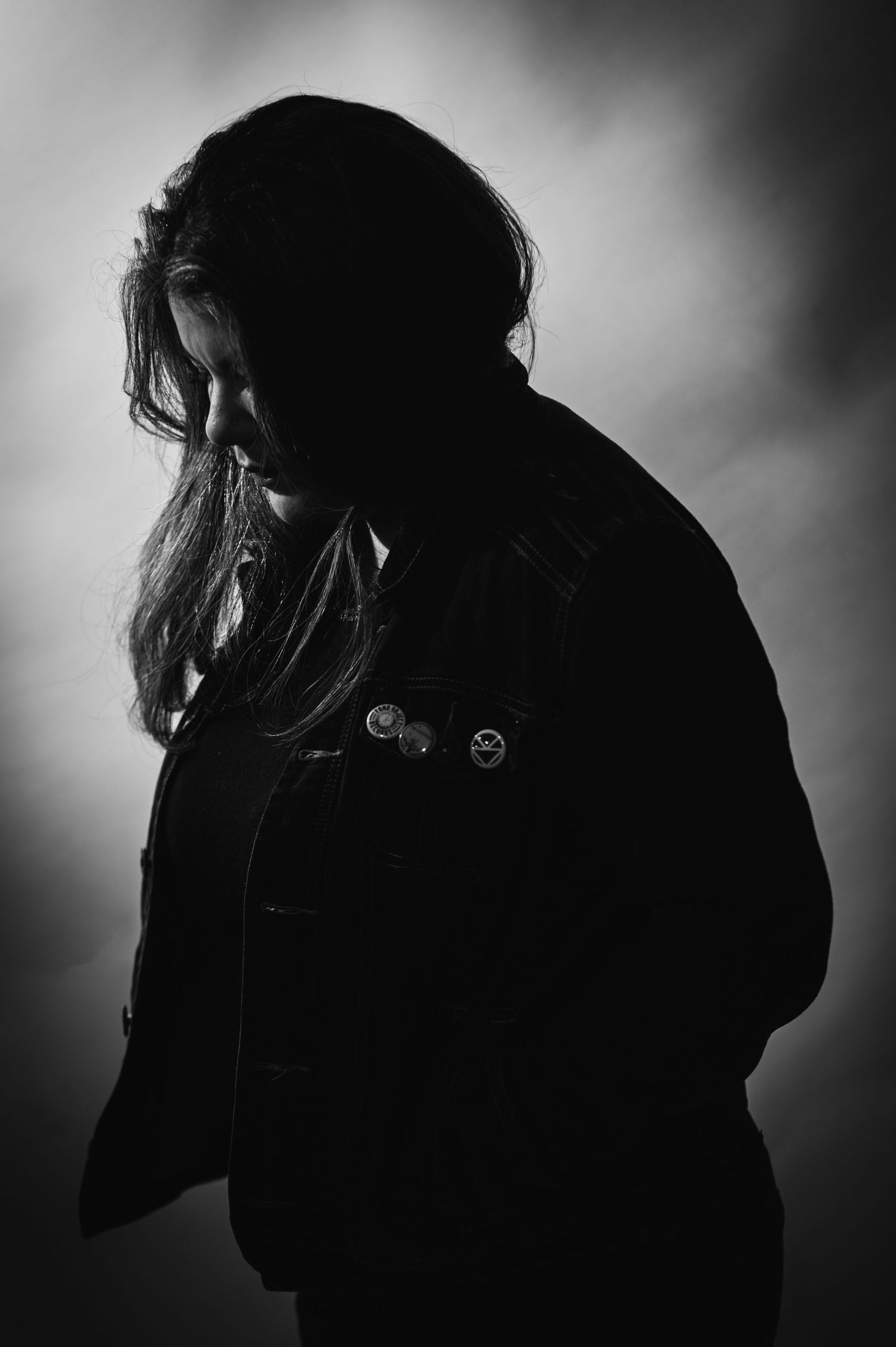 A series of black and white silhouette profile portraits showing different angles and expressions in dramatic lighting.