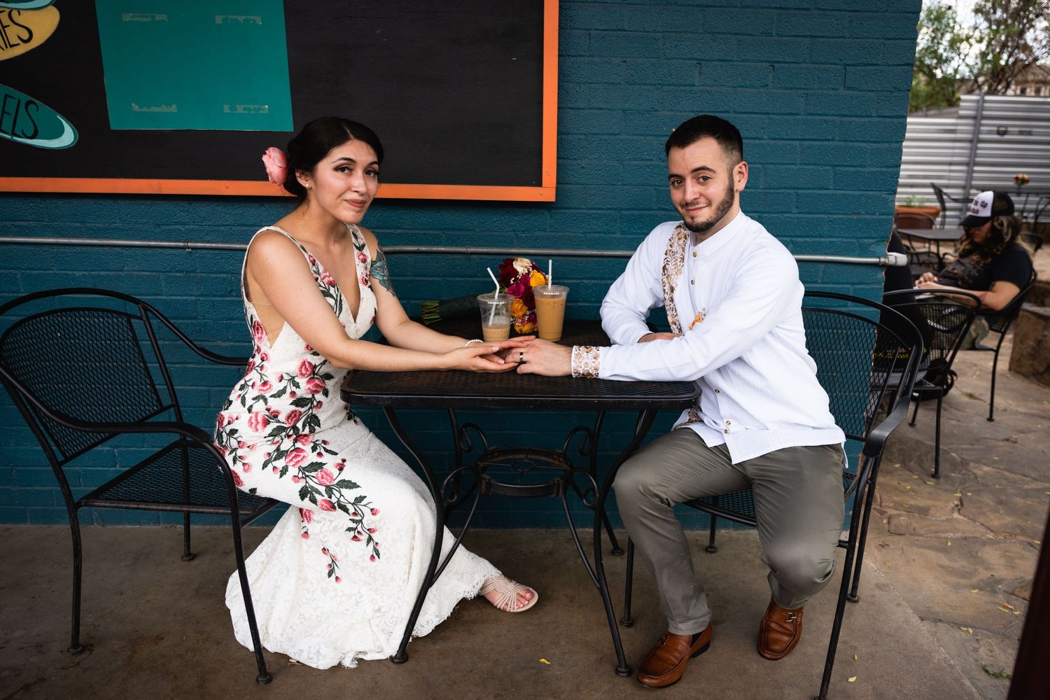 A couple enjoys drinks at an outdoor cafe table.
