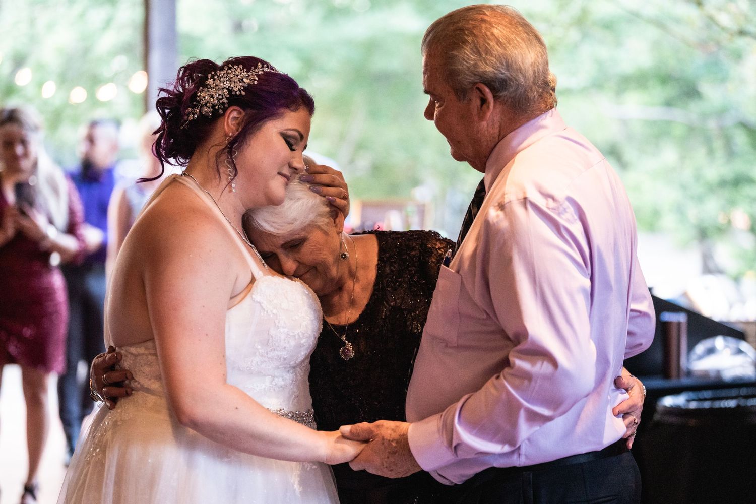 An emotional dance moment at an indoor wedding reception.