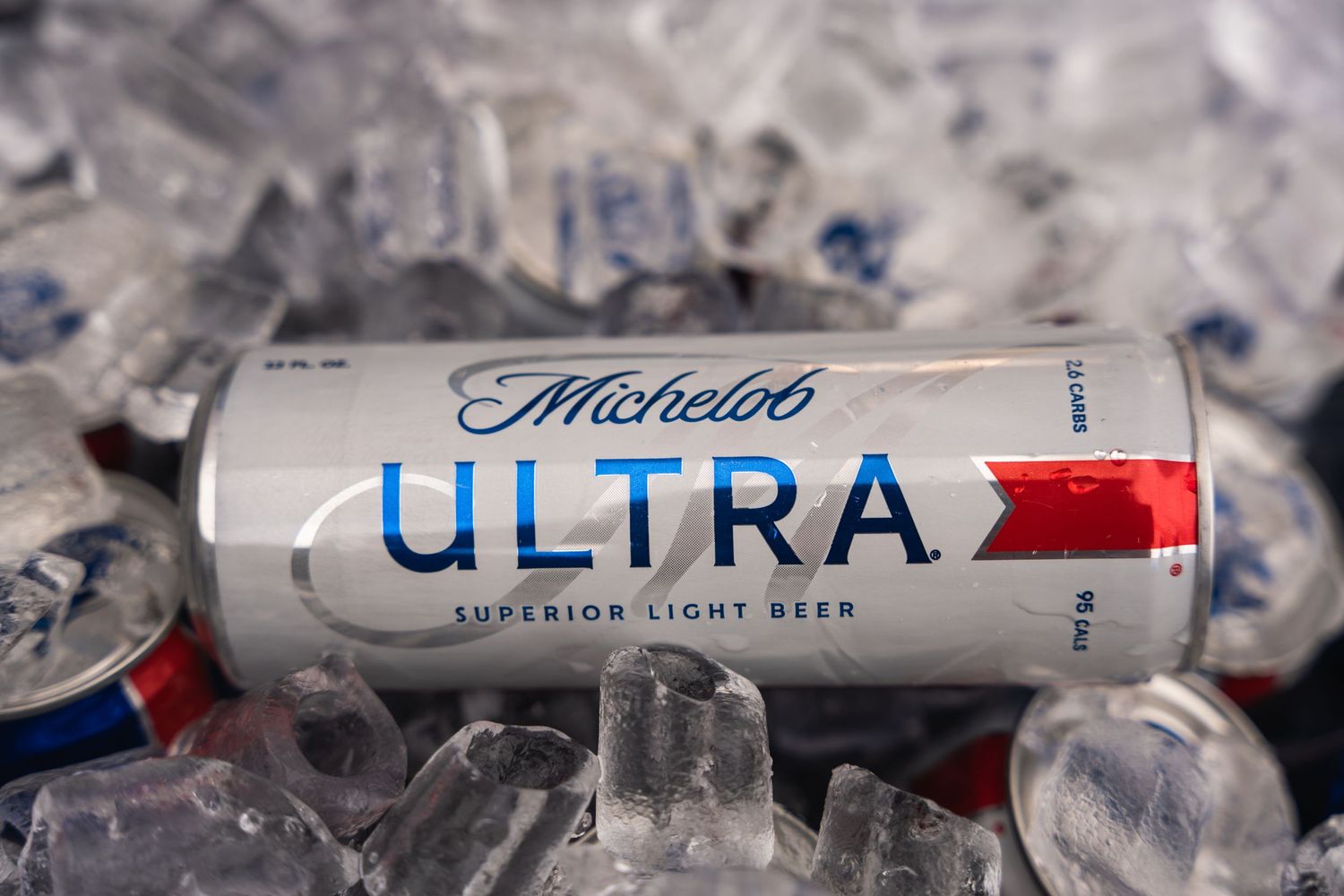 Michelob Ultra can nestled in ice with sleek silver design.