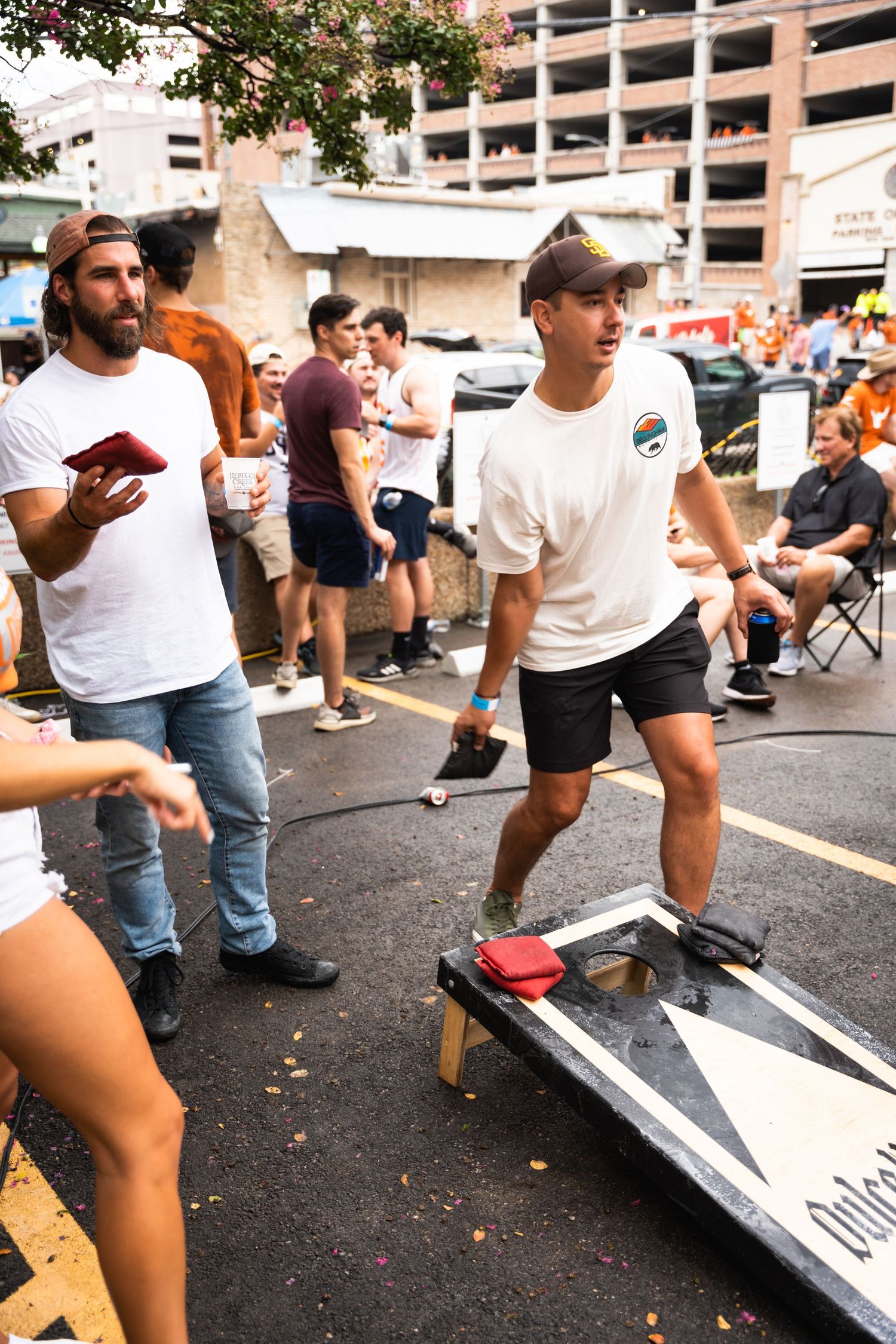 People playing games at outdoor tailgate event.