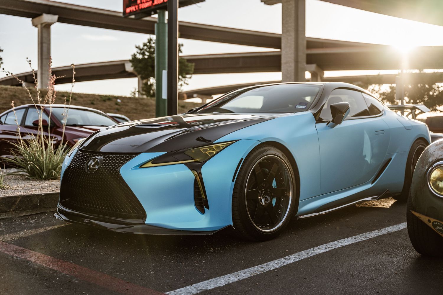 Light blue Lexus LC sports car parked in low sunlight.