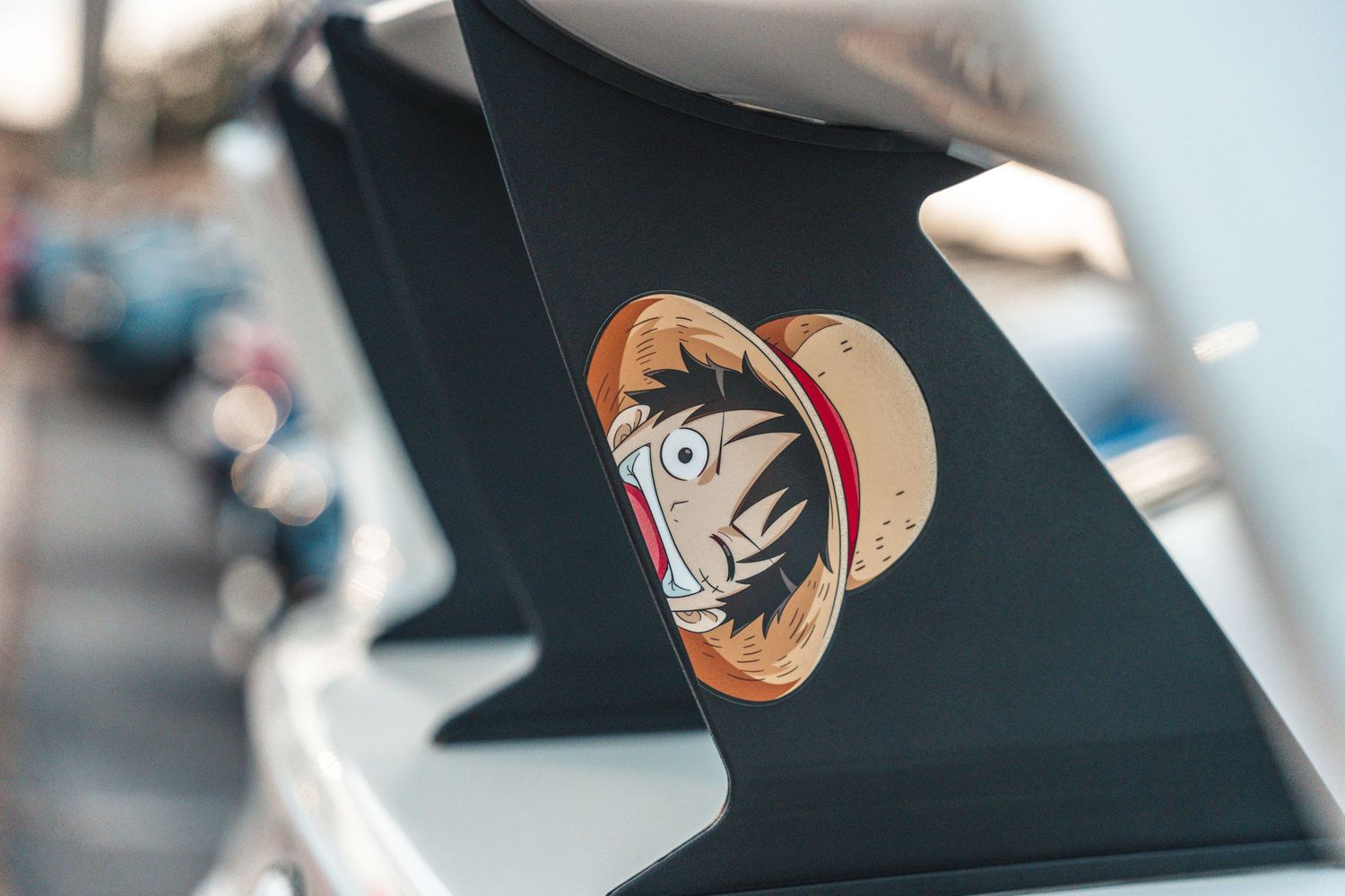 Custom cartoon decal featuring character with red hat on black car panel.