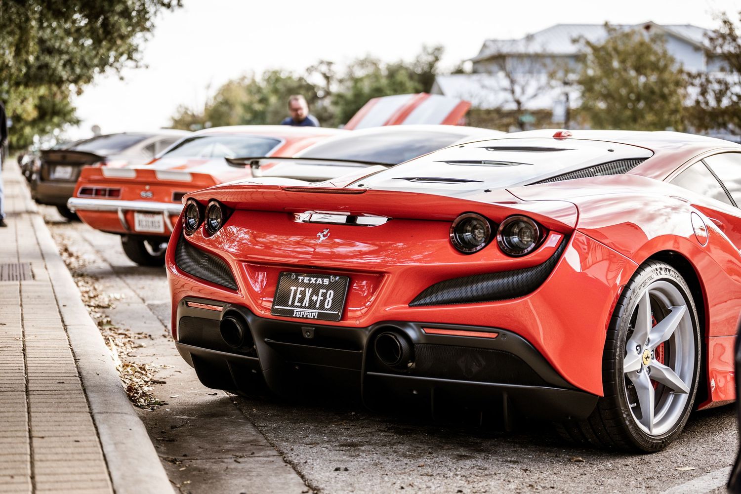 Rear view of a red Ferrari F8 Tributo sports car parked on a street.