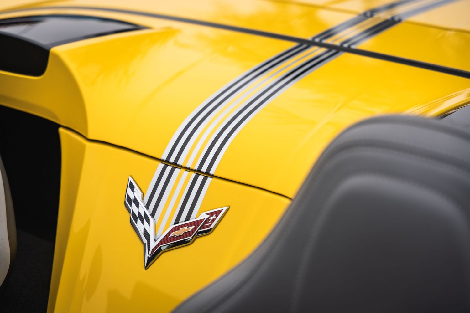 Yellow Corvette panel featuring the iconic crossed flags emblem and racing stripes.