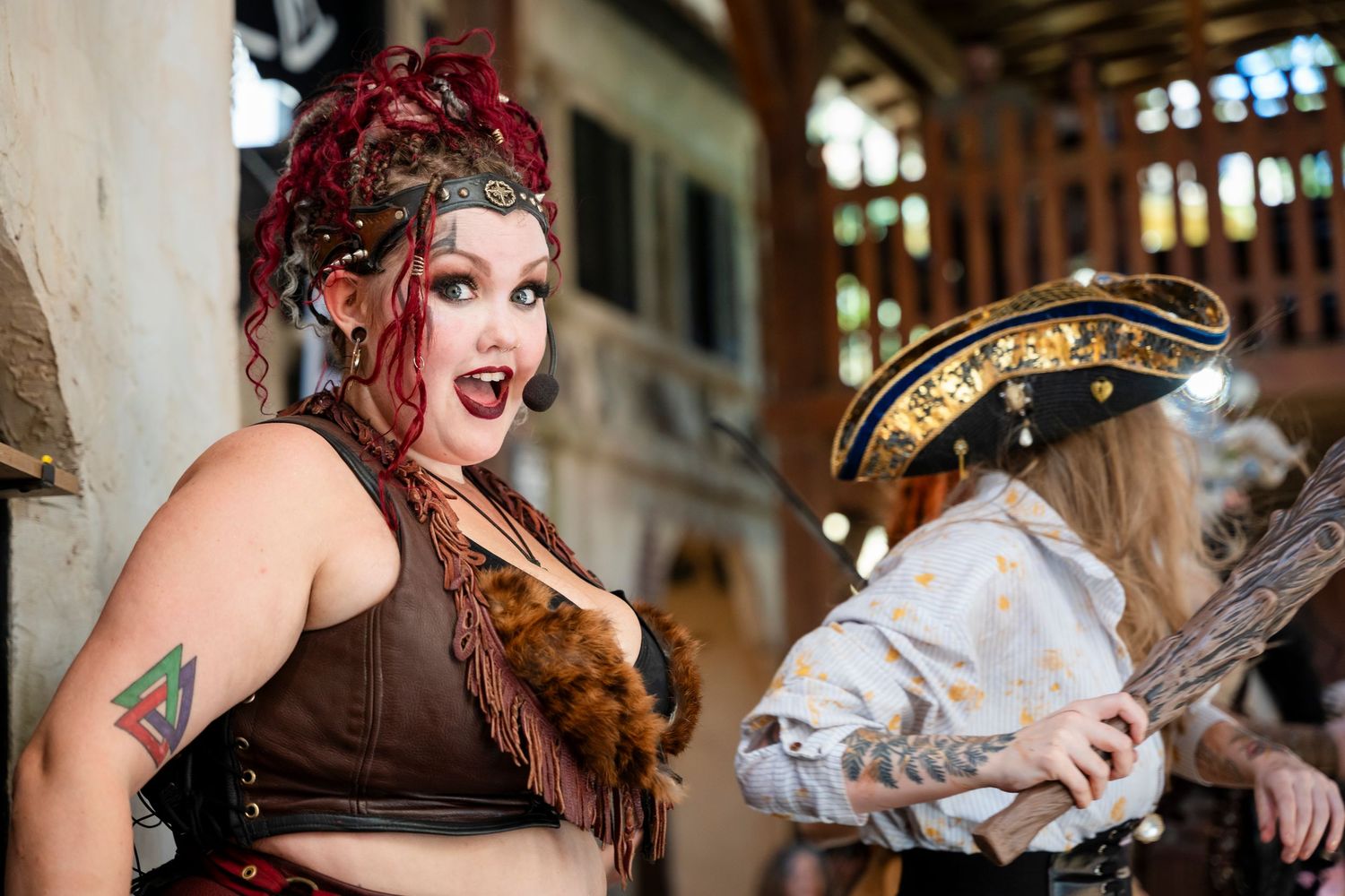 A group of steampunk-themed wedding party members pose together in vintage-inspired costumes and accessories.