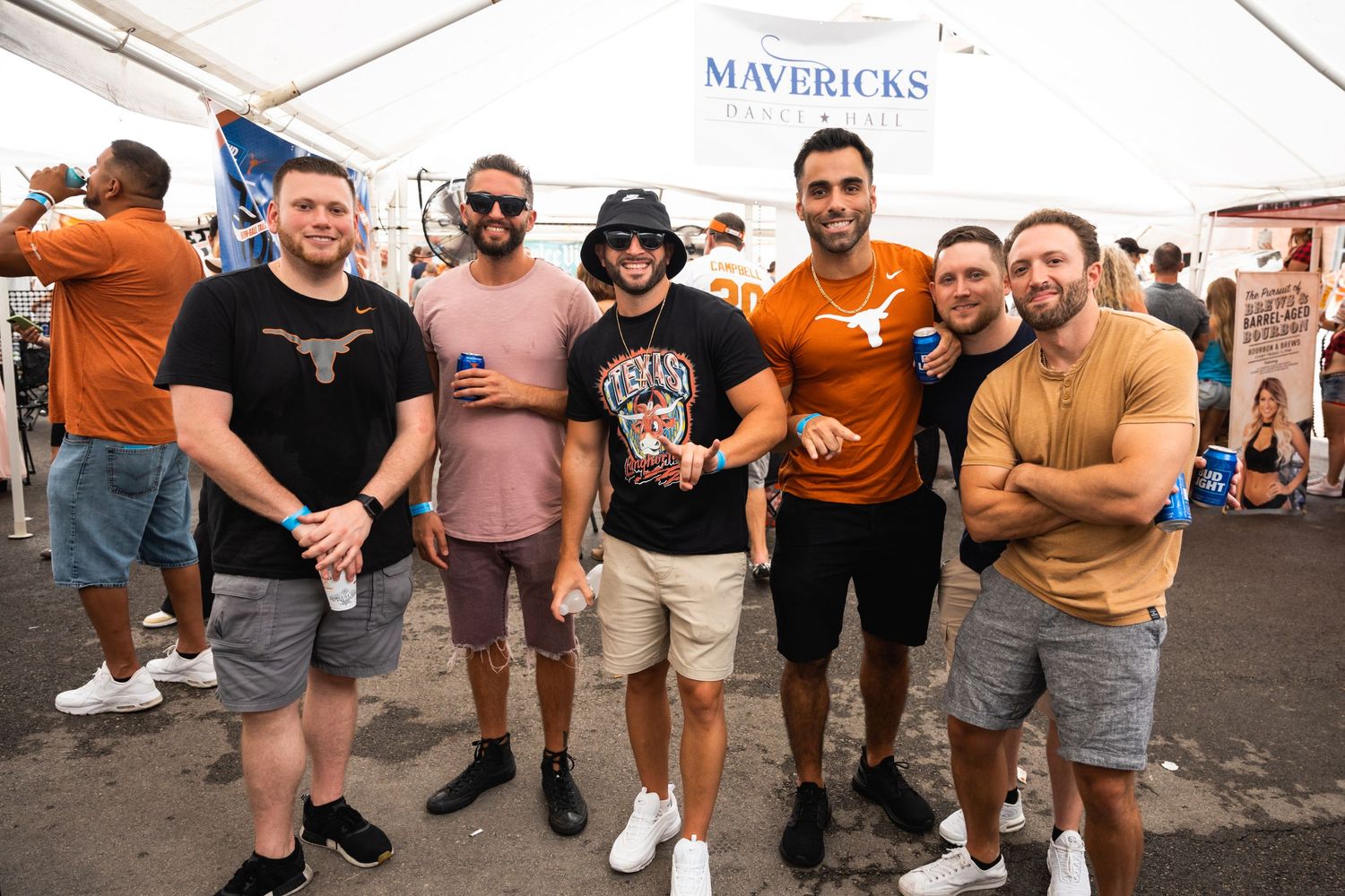 Group of friends in casual attire posing together at a Mavericks event.