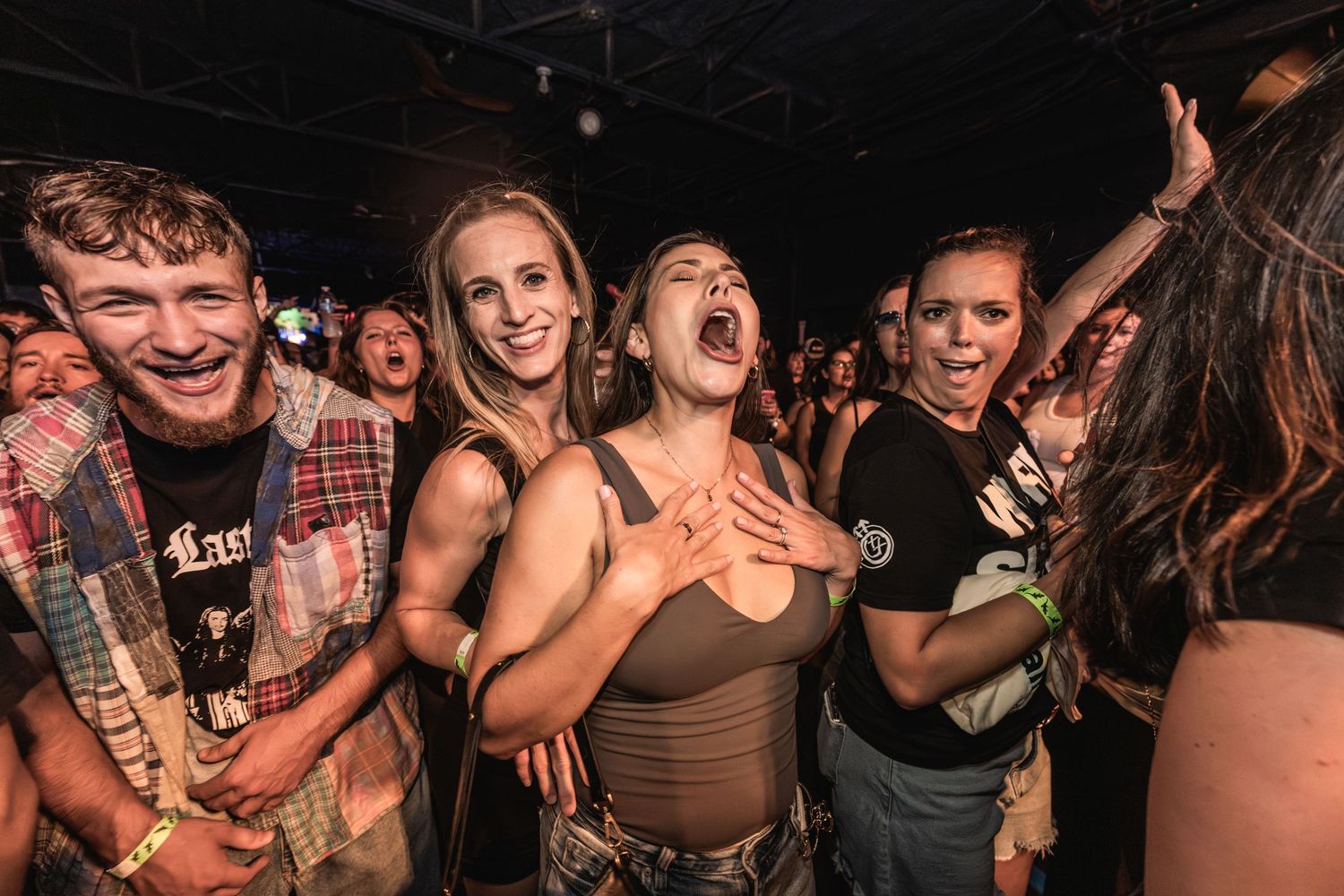 Energetic concert audience reacting with excitement to live music performance.