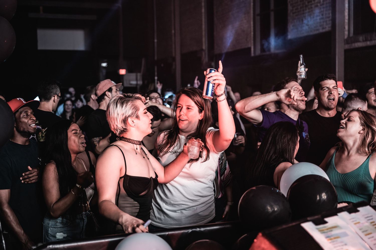 Energetic crowd at a concert venue reacts enthusiastically to the performance.