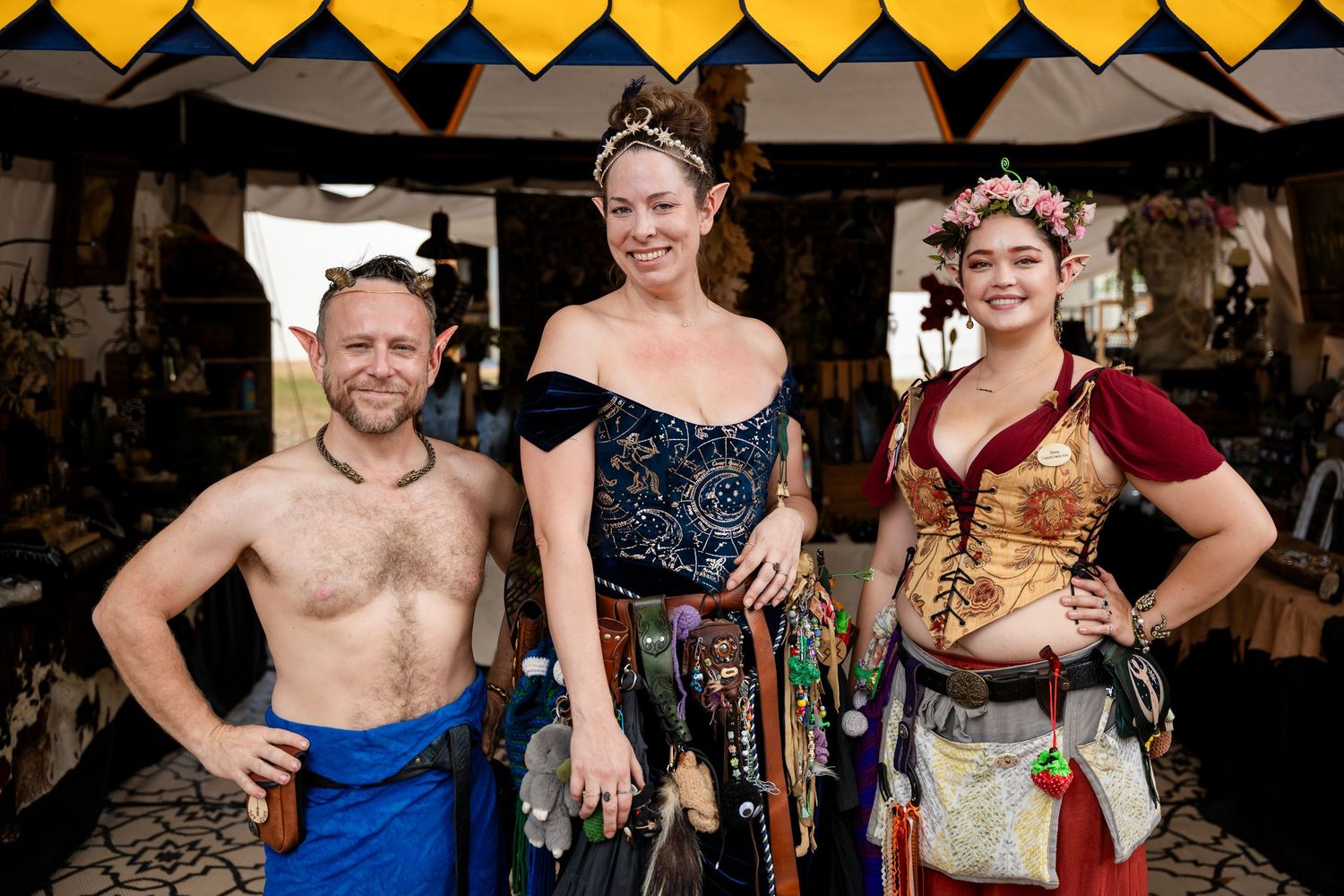 Performers in medieval and renaissance costumes pose together at a festival or faire event.