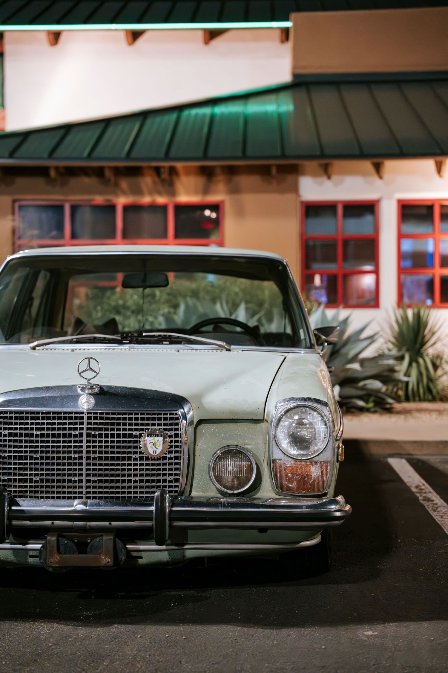 Front view of classic Mercedes-Benz sedan showing iconic grille and headlights.