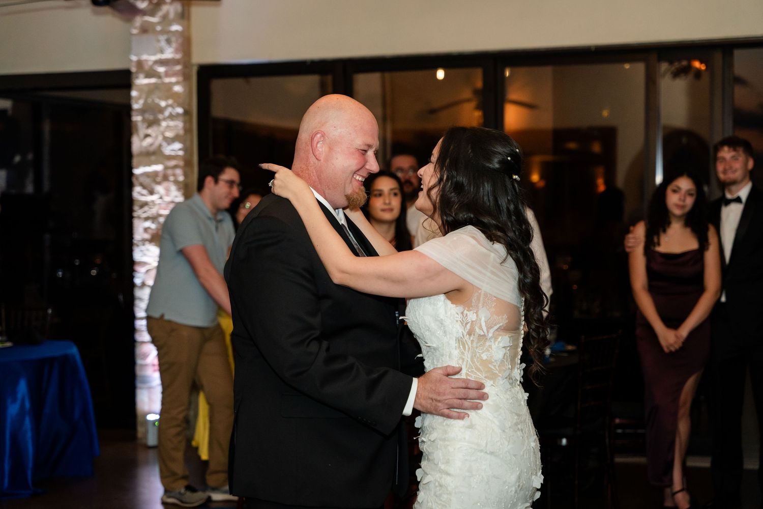 Tender moment during wedding dance in elegant indoor venue.