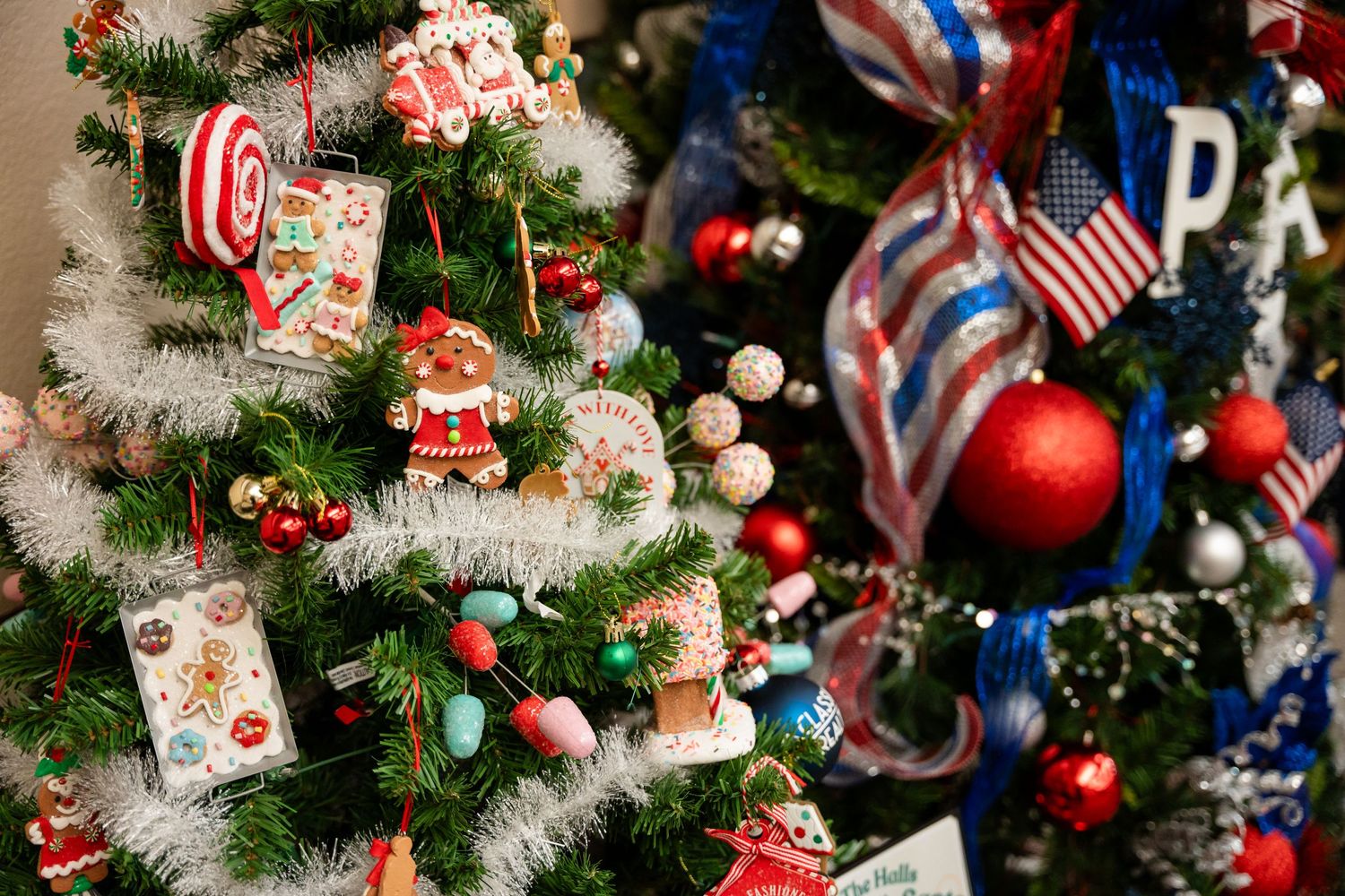 A Christmas tree decorated with patriotic ornaments, ribbons, and red white and blue decorations.