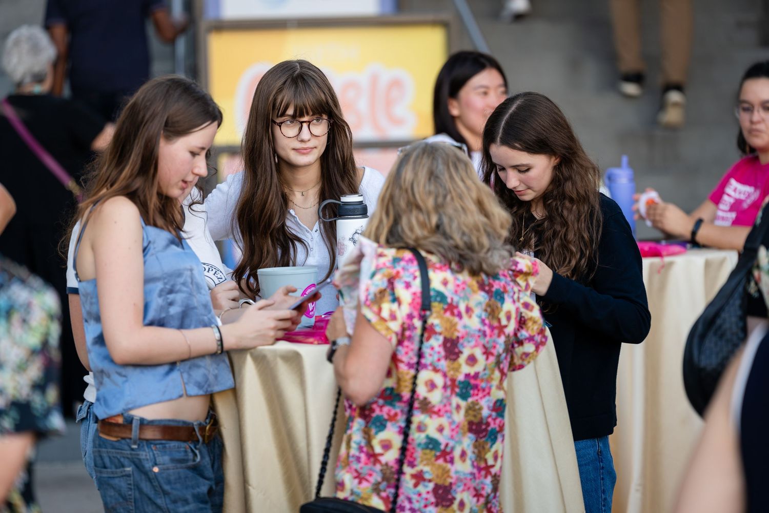 Group of attendees gathered in casual conversation at a social event.