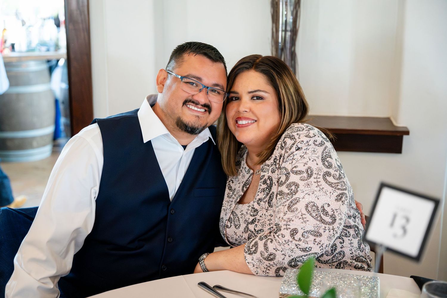 A loving couple enjoys a romantic candlelit dinner at an elegant restaurant.