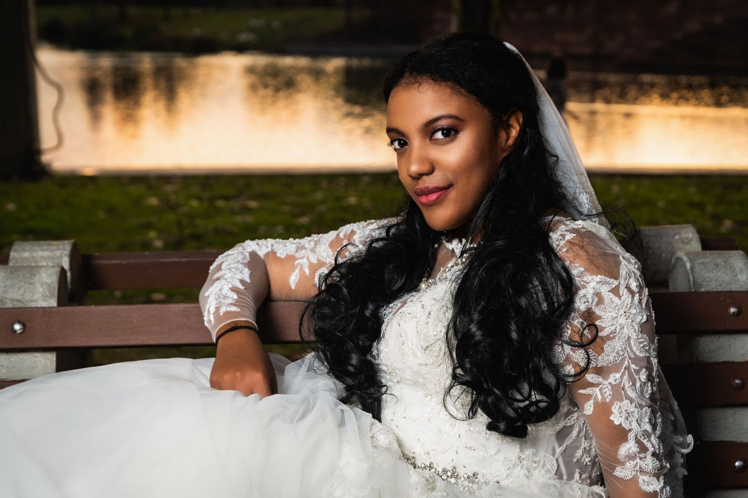 Relaxed bridal portrait on wooden bench with natural lighting.