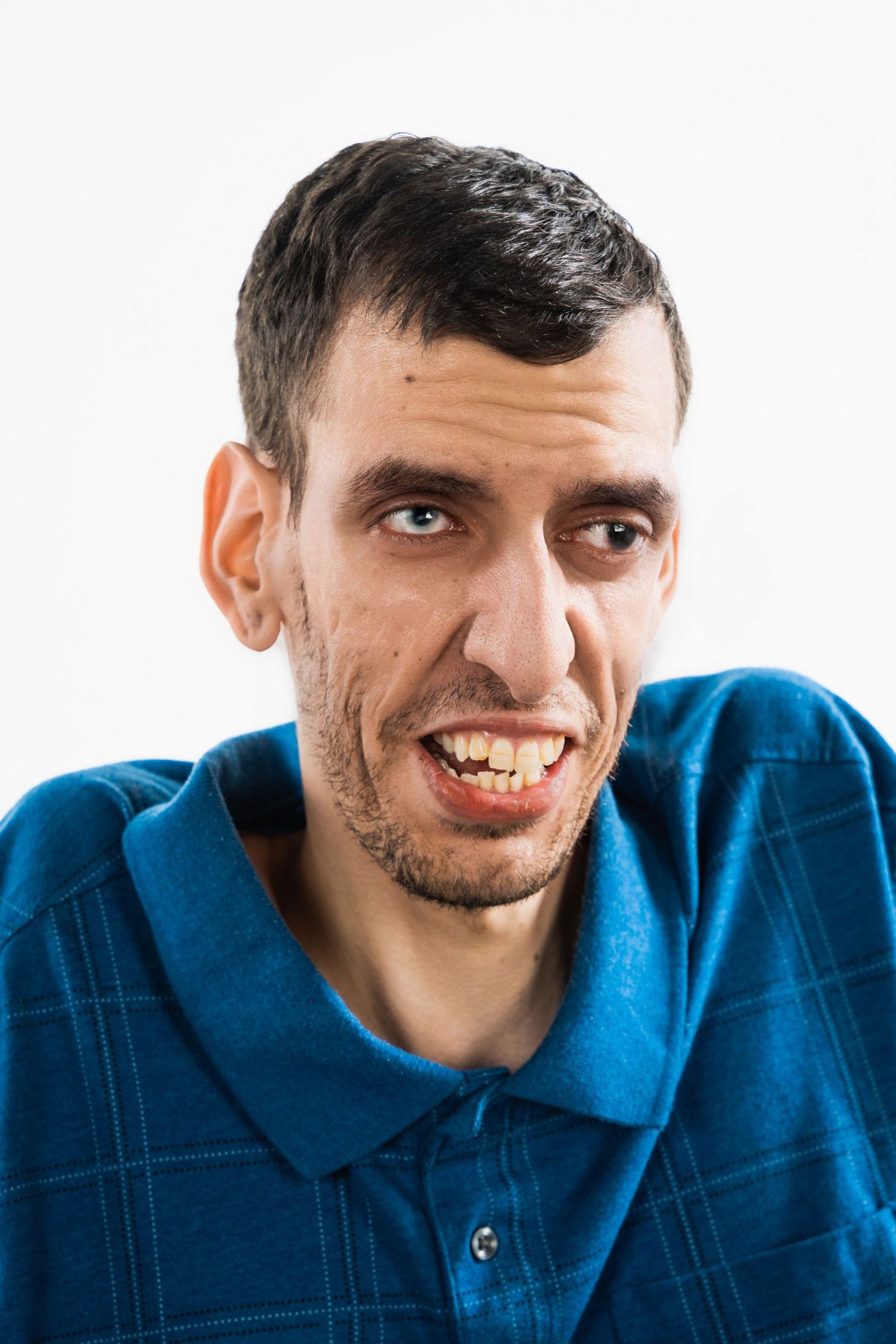 Portrait of person in blue polo shirt against white background.