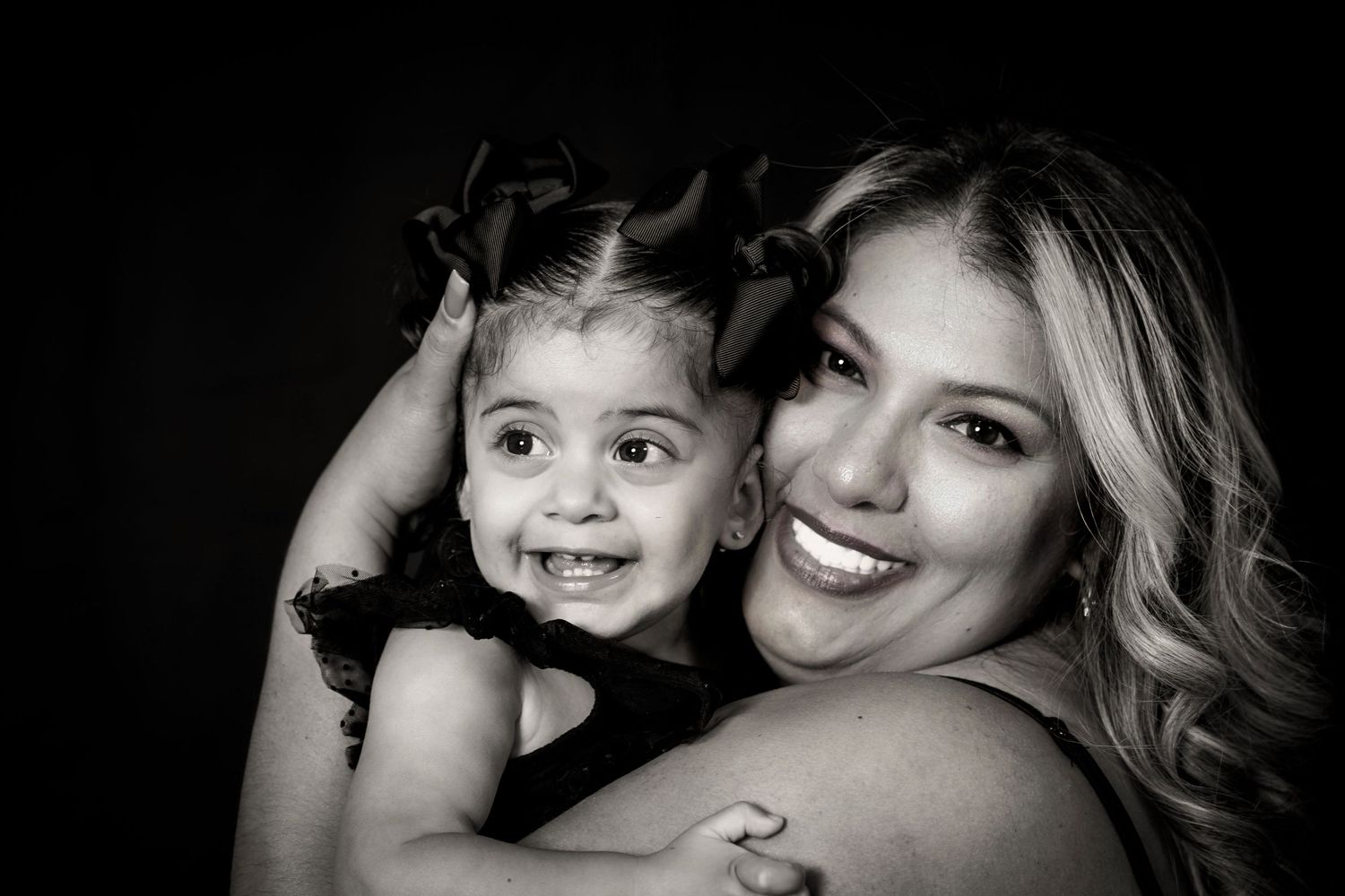 Heartwarming black and white portrait showing affectionate moment between parent and child.