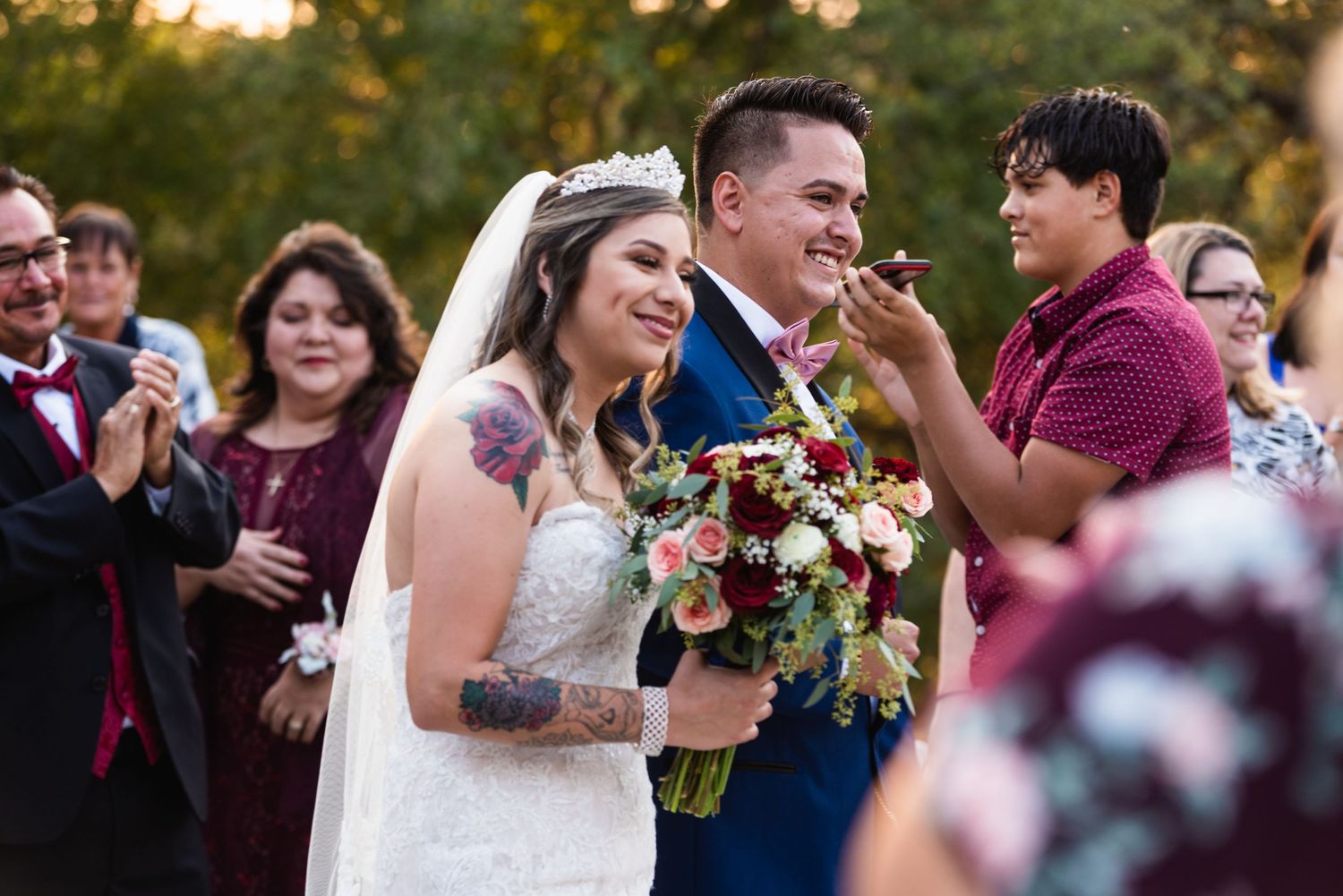 A joyful wedding ceremony moment with an autumn bouquet of flowers.