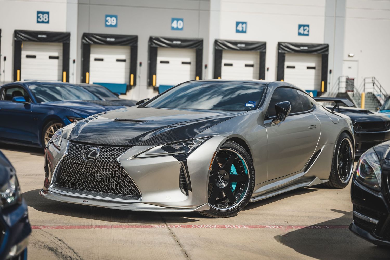 Custom Lexus LC500 in metallic grey with aftermarket wheels and body modifications.