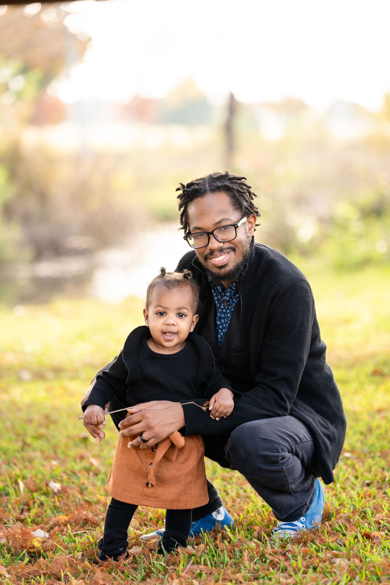 A cheerful outdoor portrait taken among fallen autumn leaves.
