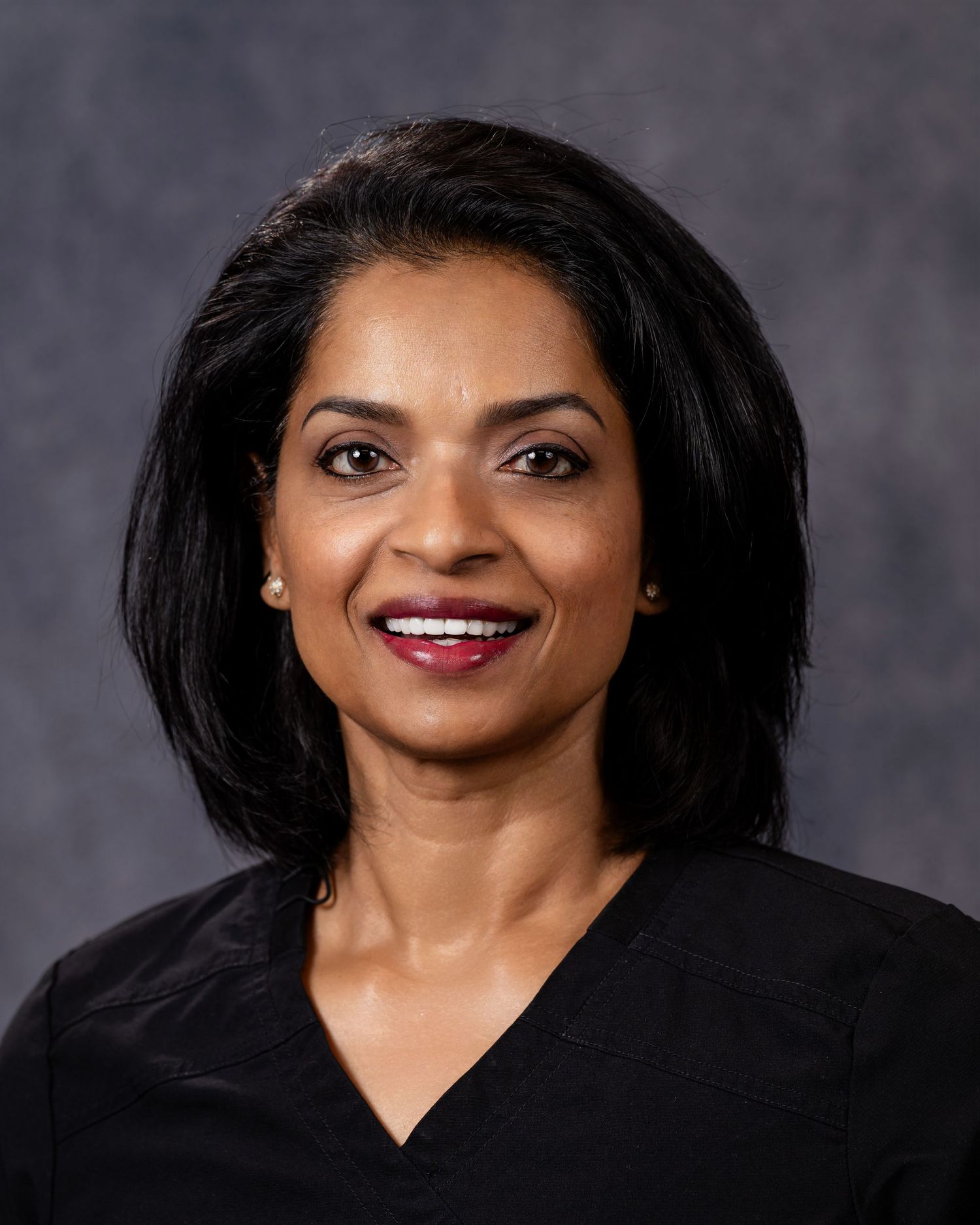 Professional headshot series showing different angles and expressions against a dark gray studio background.