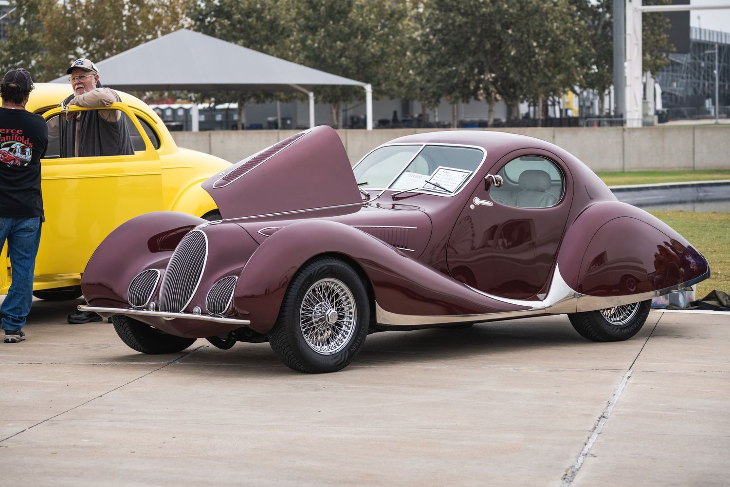 Vintage burgundy Talbot-Lago classic car with sweeping art deco bodywork at car show.
