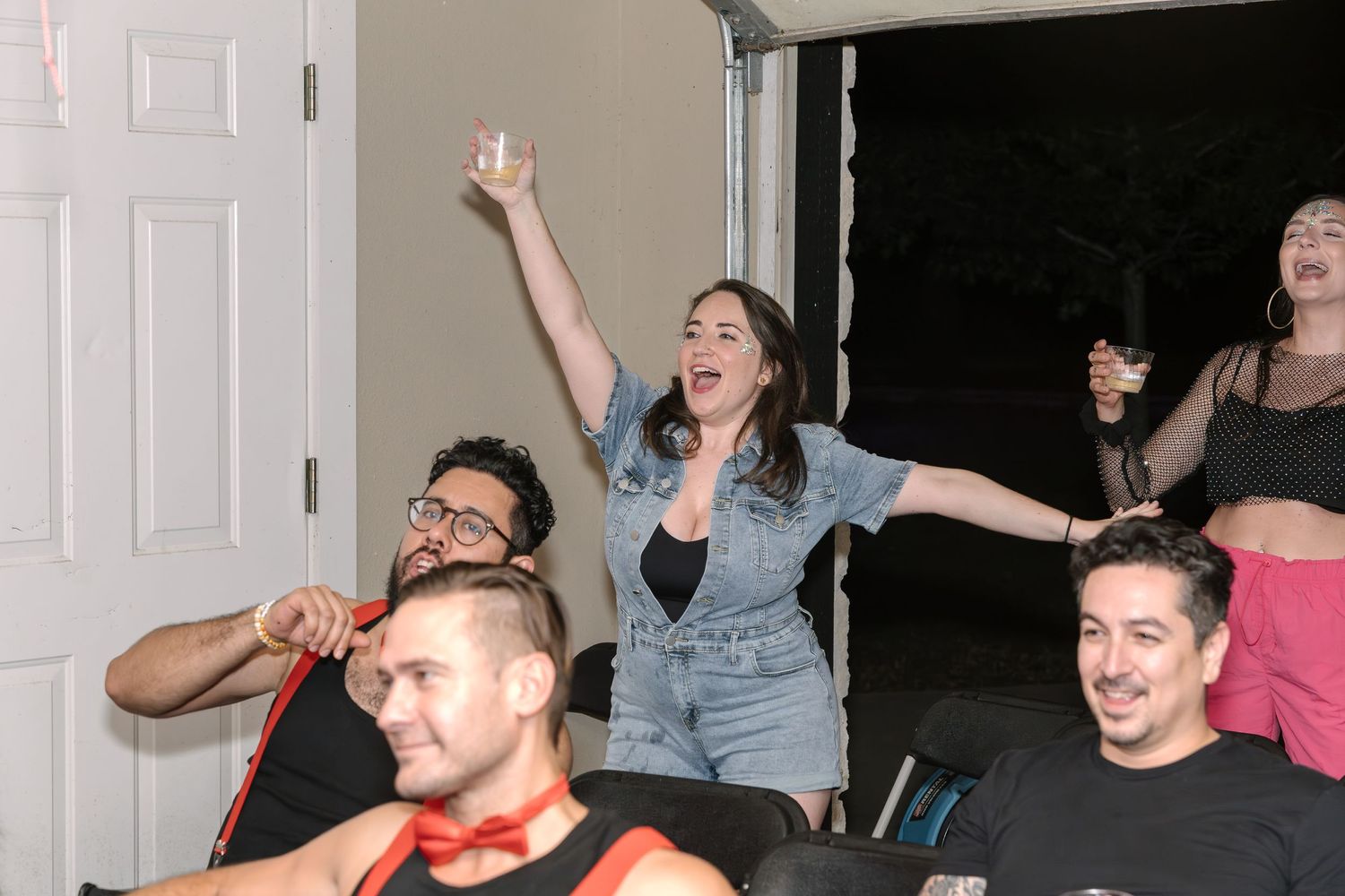 People celebrating and cheering enthusiastically during an indoor event.
