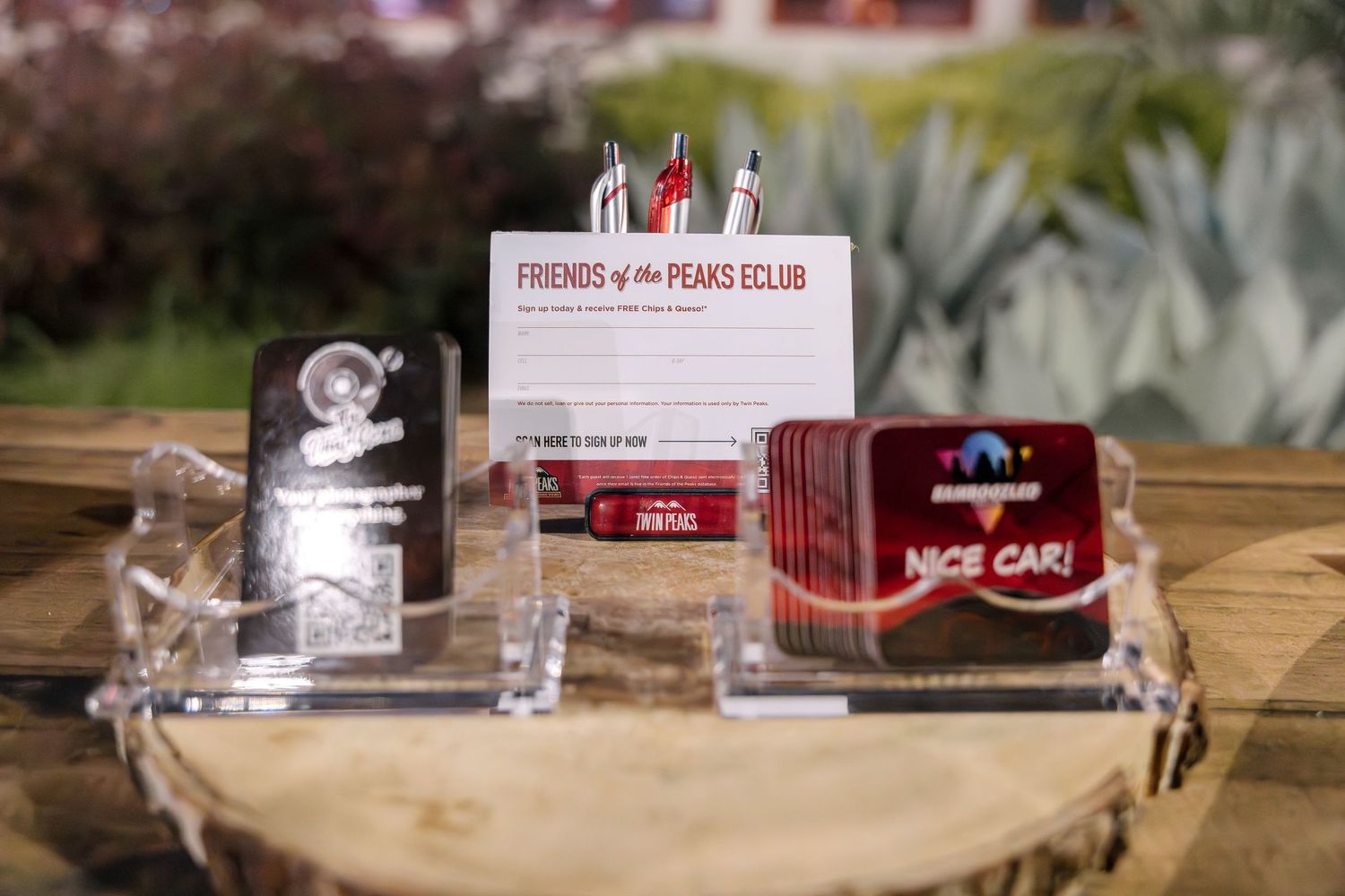 Display of membership cards and promotional materials on wooden surface.