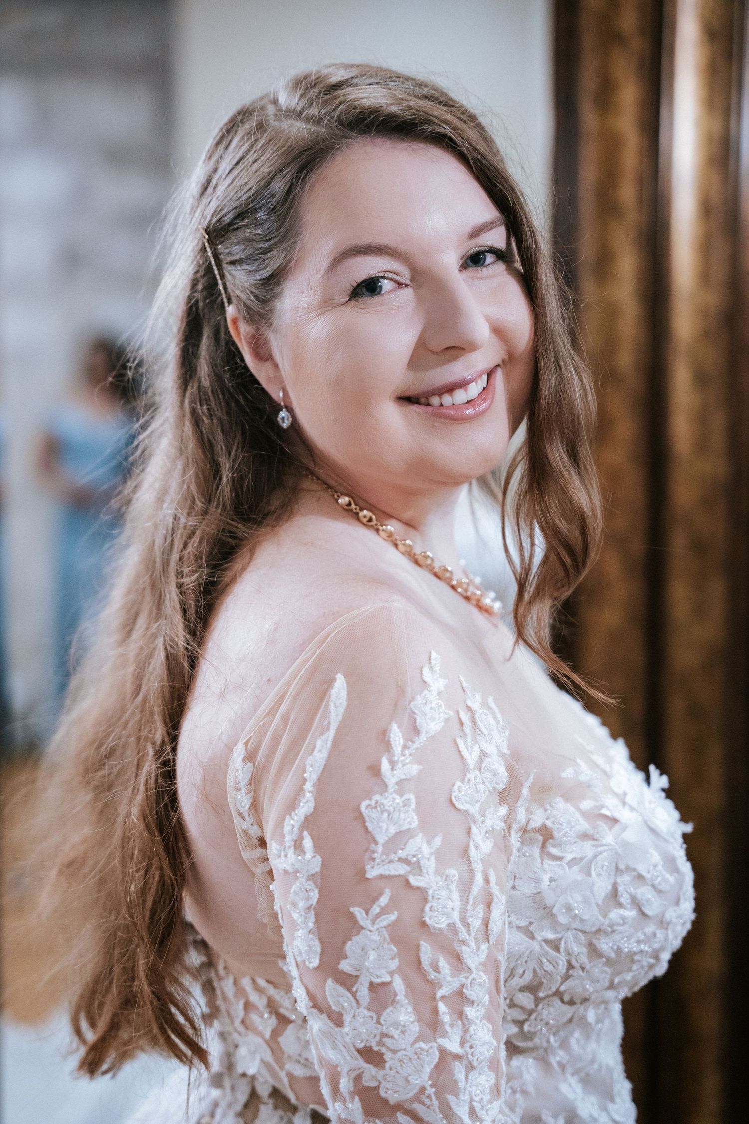 A wedding dress with delicate lace details and sheer long sleeves.
