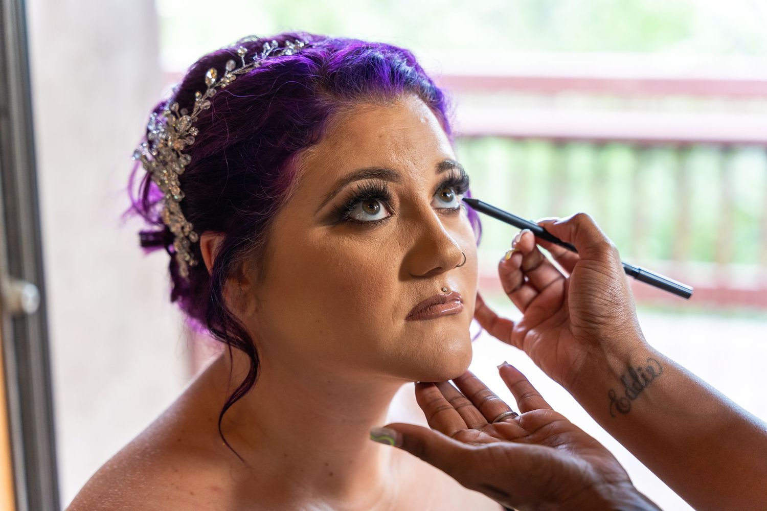 Professional makeup application being done with mascara brush.