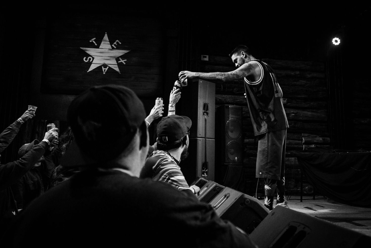 Black and white concert photo showing interaction between performer and audience.