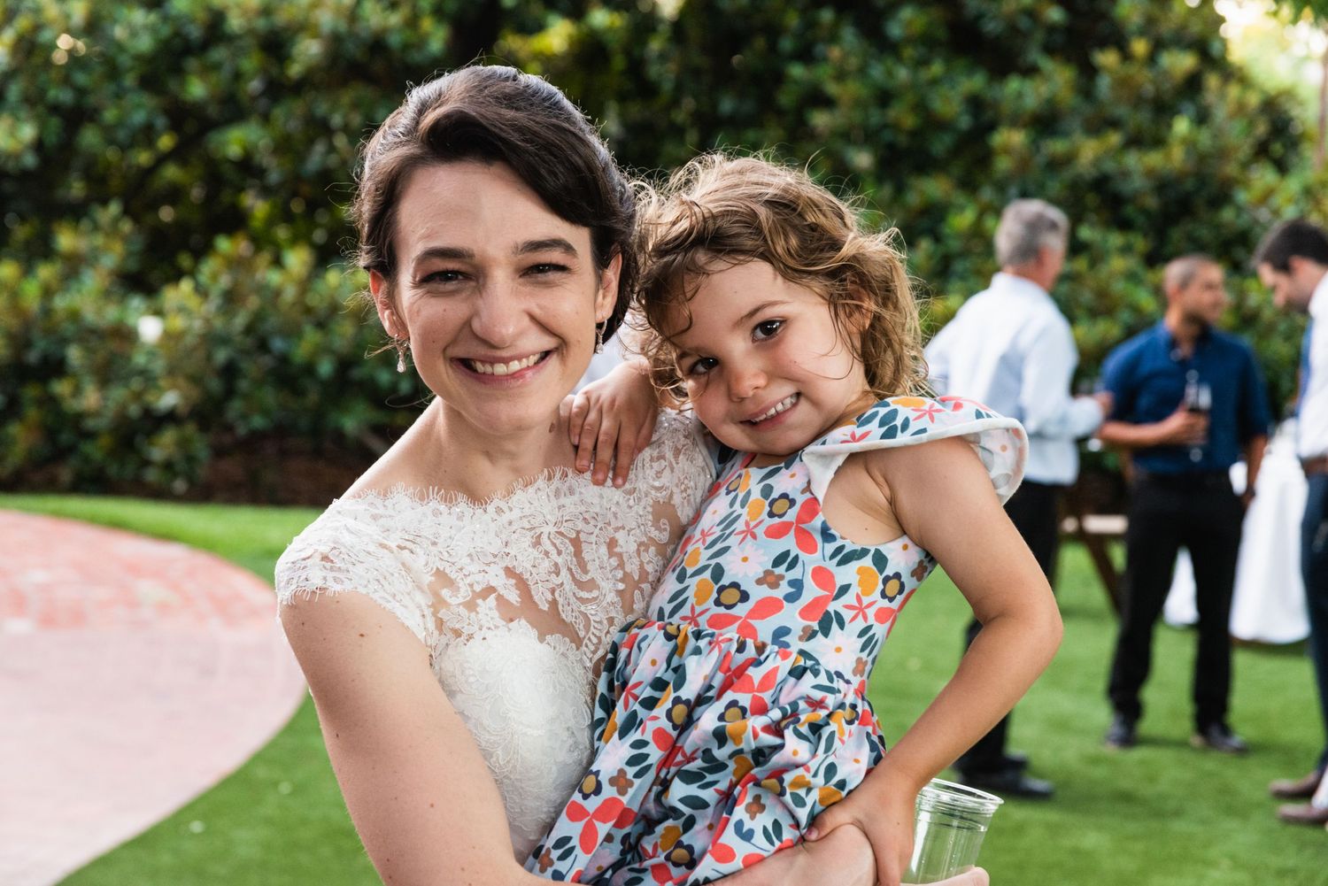 A heartwarming moment shared between two guests at an outdoor garden wedding.