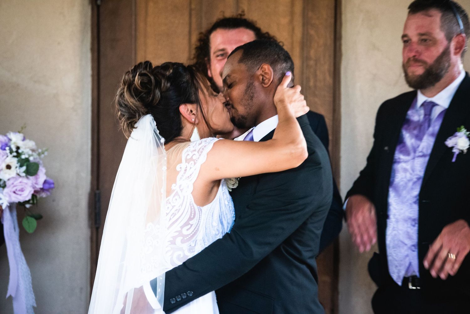 A passionate kiss shared between newlyweds during their wedding ceremony.