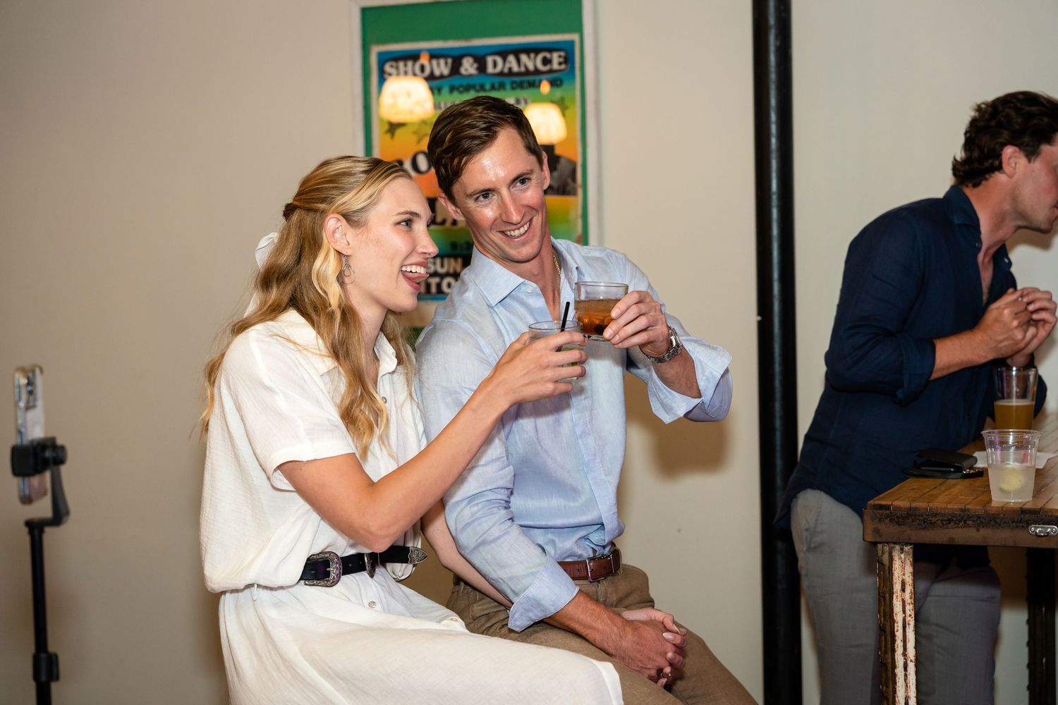 Guests enjoying drinks and conversation at a casual indoor gathering.