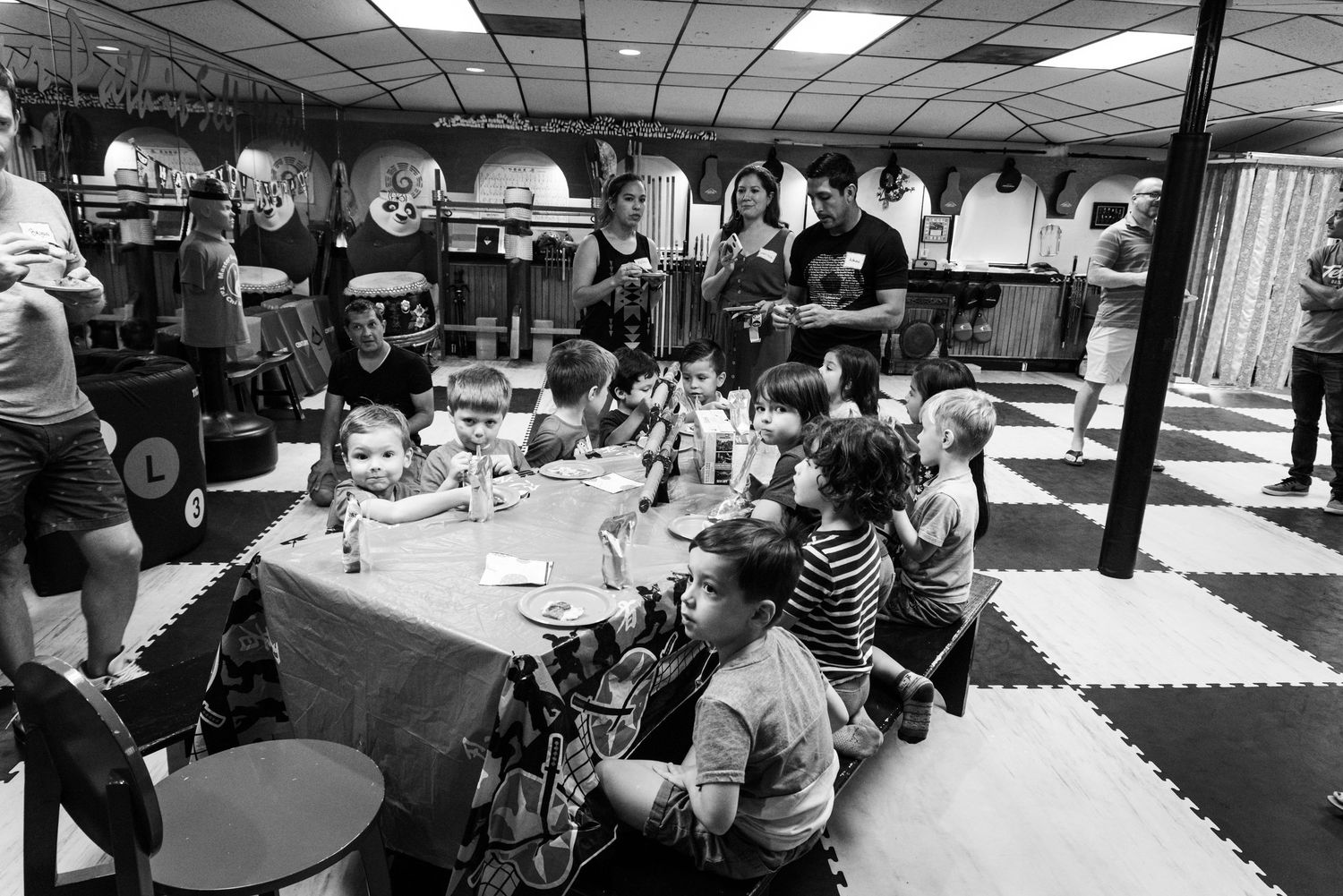 People gathered at tables in a community space for a gaming or hobby event.