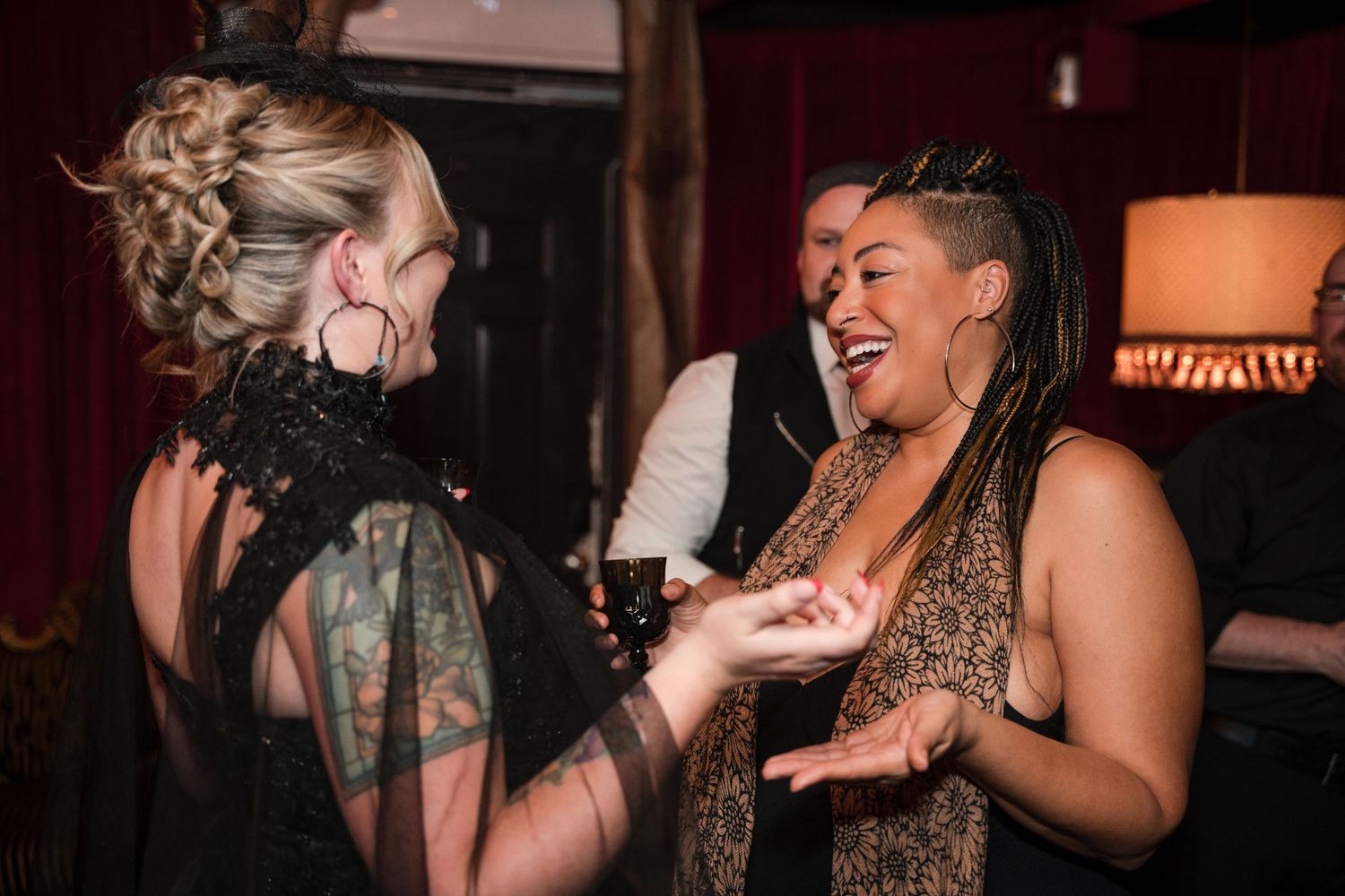 Four candid photos of performers singing and dancing energetically on stage during a live entertainment show.