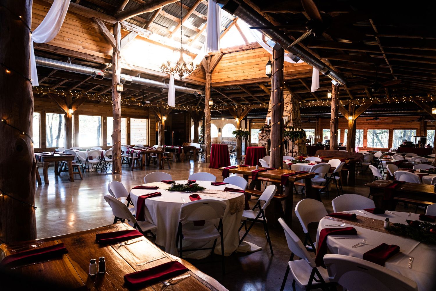 Interior view of a rustic restaurant dining room with exposed wooden beams and soft lighting creating an intimate atmosphere.