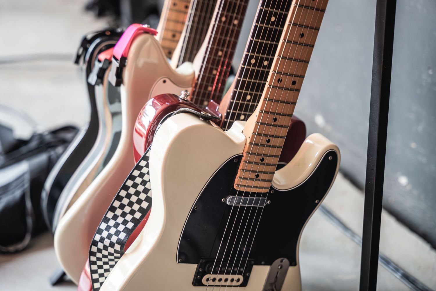 Row of electric guitars on display showcasing black and white checkerboard patterns.