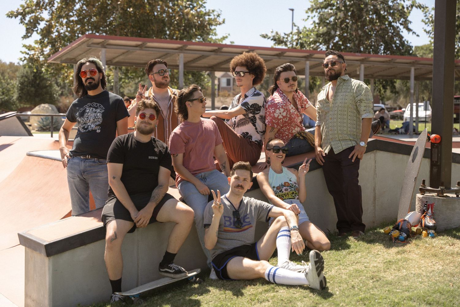 Group of friends hanging out together at outdoor skate park.