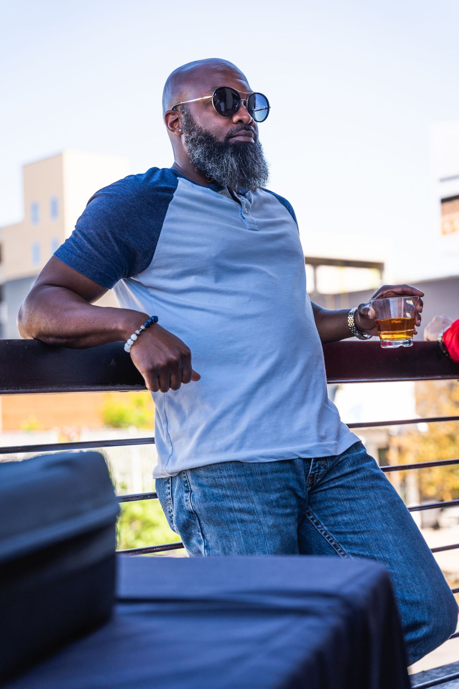Person in casual attire enjoying a beverage at an outdoor event.